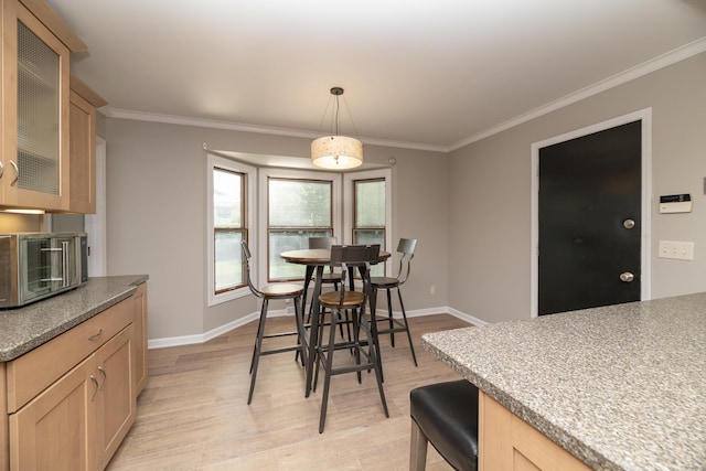 6615 Pleasantview Dr, Portage, MI 49024 - dining area featuring light wood finished floors and ornamental molding
