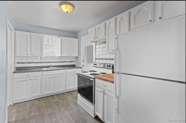 21916 Oakwood Ave, Washington, MI 48021 - kitchen with white appliances, white cabinetry, tasteful backsplash, and light wood finished floors