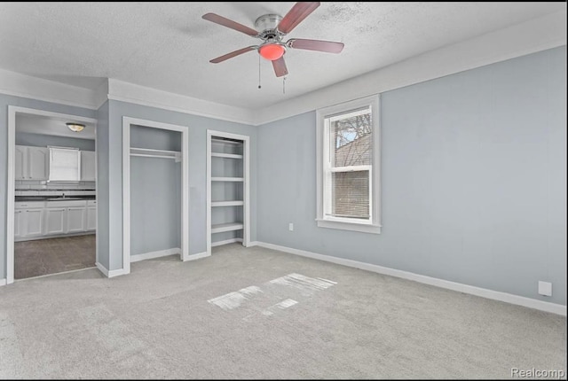 21916 Oakwood Ave, Washington, MI 48021 - unfurnished bedroom with a textured ceiling, light colored carpet, a closet, and a ceiling fan