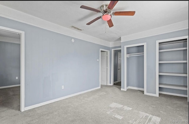 21916 Oakwood Ave, Washington, MI 48021 - unfurnished bedroom featuring carpet floors, two closets, and ceiling fan