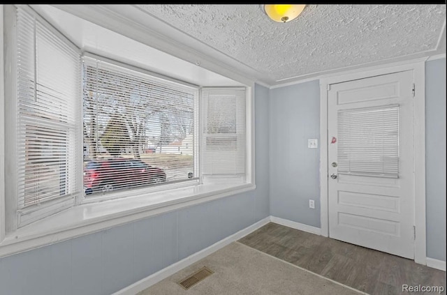 21916 Oakwood Ave, Washington, MI 48021 - entrance foyer featuring wood finished floors, a textured ceiling, and crown molding