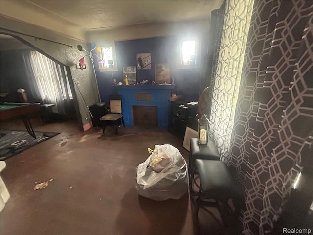 18602 Brinker St, Detroit, MI 48234 - bedroom featuring unfinished concrete floors and a fireplace