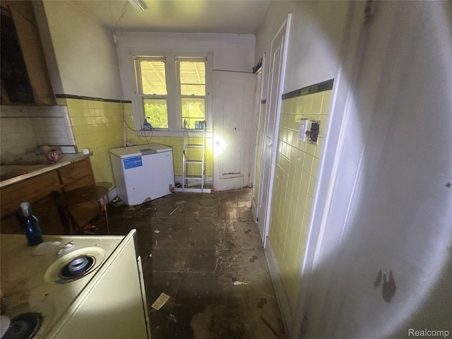 18602 Brinker St, Detroit, MI 48234 - kitchen with tile walls, fridge, and a wainscoted wall