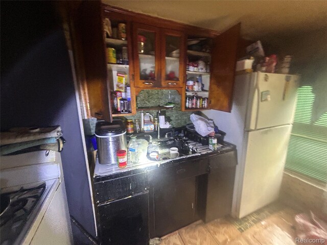 18602 Brinker St, Detroit, MI 48234 - kitchen with freestanding refrigerator and light tile patterned floors