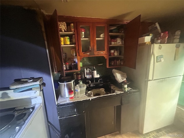 18602 Brinker St, Detroit, MI 48234 - kitchen featuring freestanding refrigerator, open shelves, and glass insert cabinets
