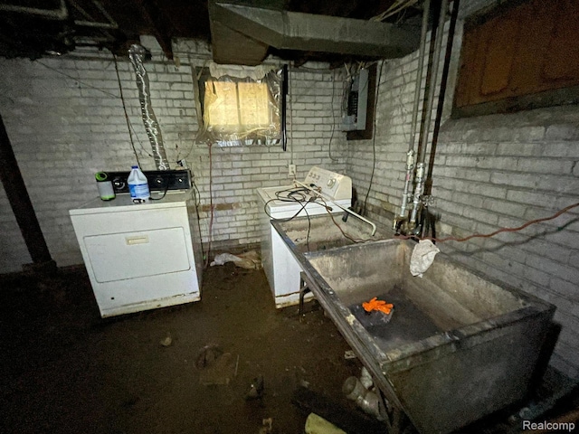18602 Brinker St, Detroit, MI 48234 - unfinished below grade area with electric panel, washing machine and dryer, and brick wall