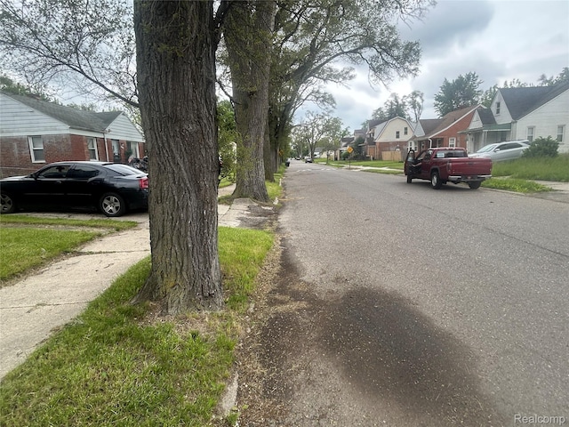 18602 Brinker St, Detroit, MI 48234 - view of asphalt road with a residential view, sidewalks, and curbs