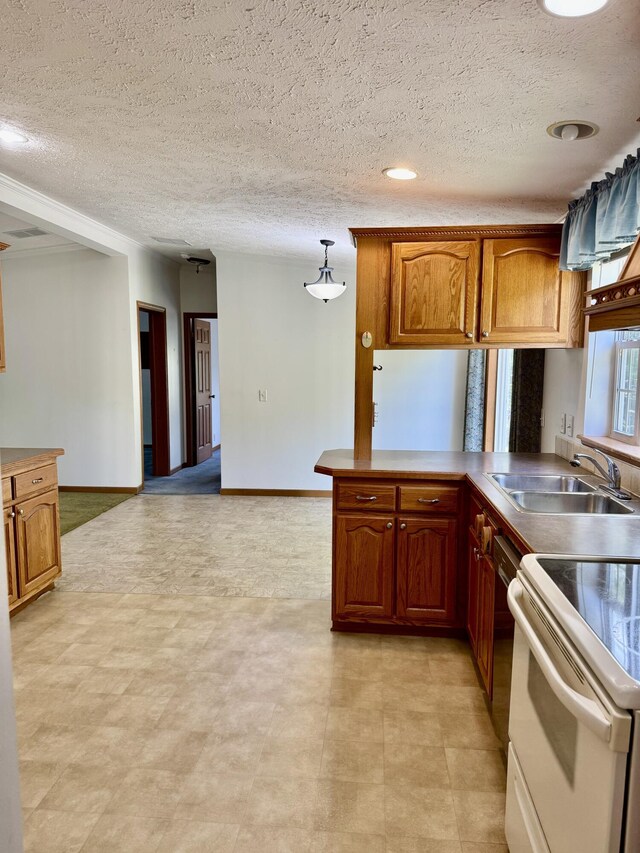 8484 Zosel St, Onekama, MI 49675 - kitchen with white electric stove, a textured ceiling, brown cabinets, and a peninsula