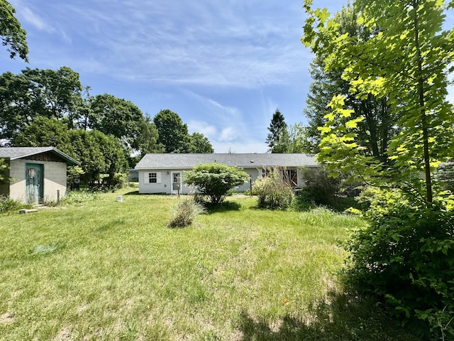 8484 Zosel St, Onekama, MI 49675 - view of green lawn with a storage shed