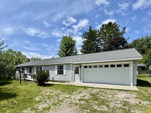 8484 Zosel St, Onekama, MI 49675 - single story home with driveway, an attached garage, and a front lawn