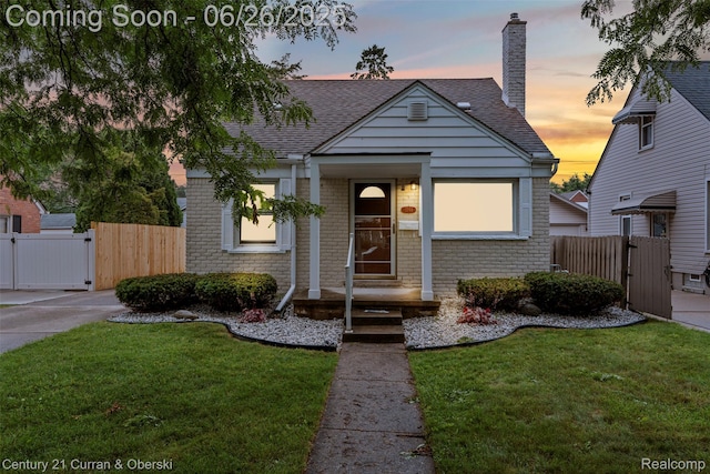 3244 Mckinley St, Canton, MI 48124 - view of front of property featuring a gate, brick siding, a chimney, and roof with shingles