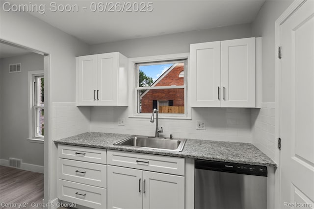 3244 Mckinley St, Canton, MI 48124 - kitchen featuring stainless steel dishwasher, white cabinets, and tasteful backsplash
