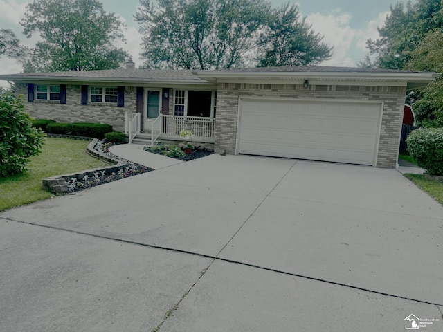 928 S Raisinville Rd, Monroe, MI 48161 - ranch-style home featuring brick siding, concrete driveway, a garage, and a chimney