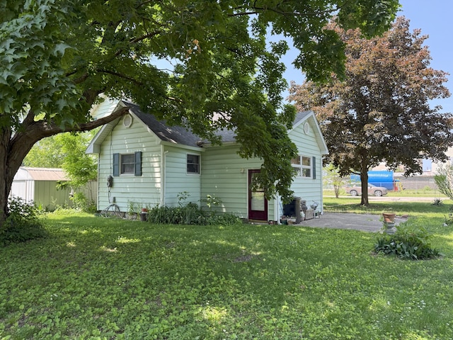 715 Filer Ave, Filer City, MI 49634 - back of property with a lawn and a shingled roof