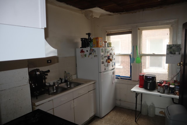 5523 Oregon St, Detroit, MI 48204 - kitchen with freestanding refrigerator, white cabinetry, light countertops, and stovetop