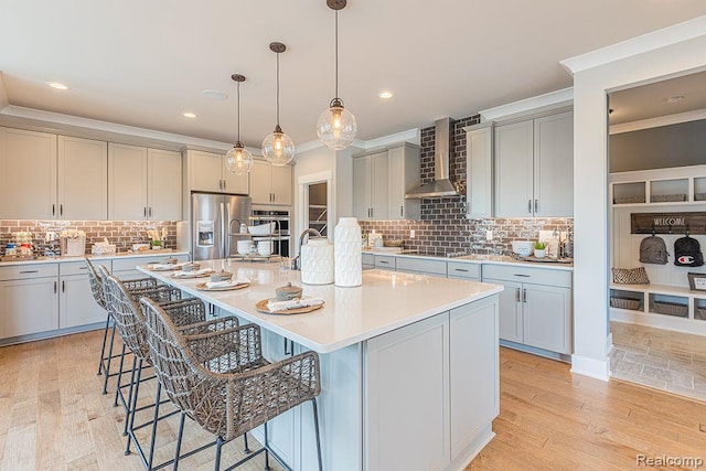 14238 Durant St, Linden, MI 48451 - kitchen featuring wall chimney range hood, stainless steel appliances, ornamental molding, a kitchen bar, and backsplash
