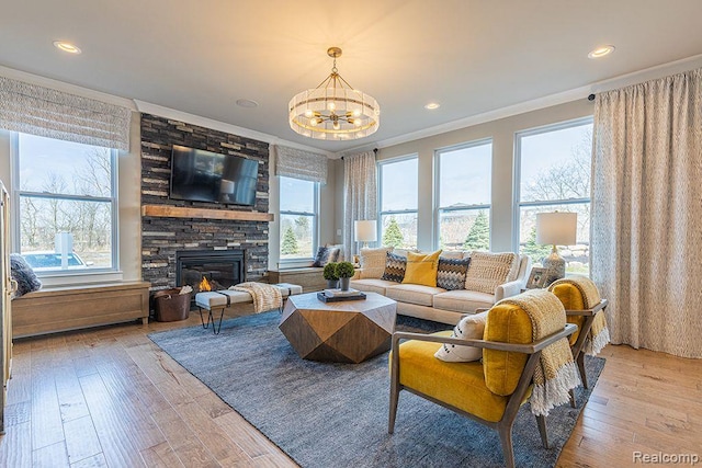 14238 Durant St, Linden, MI 48451 - living room with a chandelier, crown molding, a fireplace, light wood-style floors, and recessed lighting
