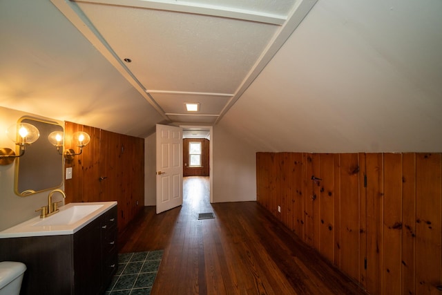 2712 Voorheis Rd, Waterford, MI 48328 - bathroom featuring wood walls, wood finished floors, vanity, lofted ceiling, and a chandelier