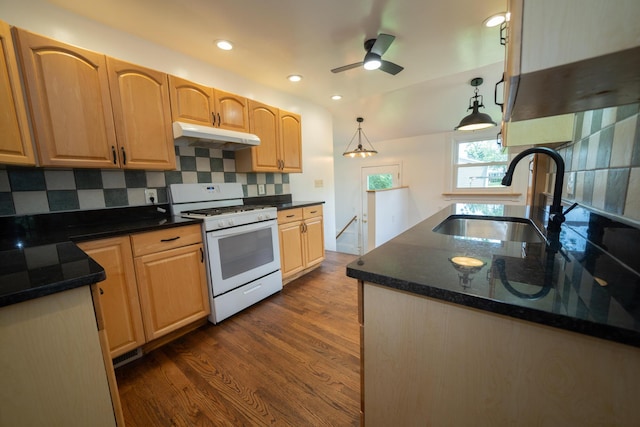 2712 Voorheis Rd, Waterford, MI 48328 - kitchen with white gas range, under cabinet range hood, tasteful backsplash, dark wood-style floors, and recessed lighting