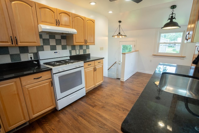 2712 Voorheis Rd, Waterford, MI 48328 - kitchen with white gas range, under cabinet range hood, dark wood-style flooring, tasteful backsplash, and recessed lighting