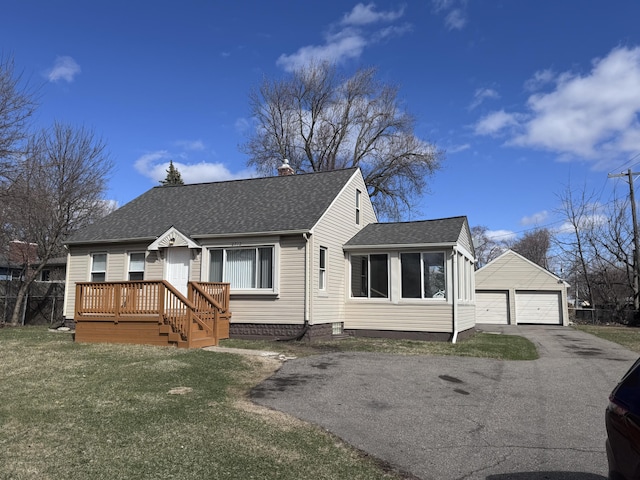 2712 Voorheis Rd, Waterford, MI 48328 - view of front facade featuring roof with shingles, a detached garage, an outbuilding, a front yard, and a chimney