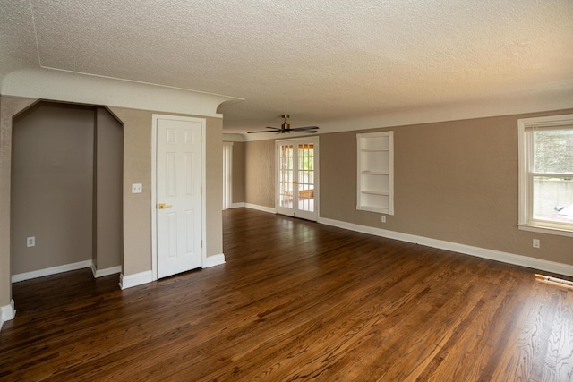 2712 Voorheis Rd, Waterford, MI 48328 - spare room featuring a textured ceiling, dark wood-style floors, plenty of natural light, built in features, and a ceiling fan
