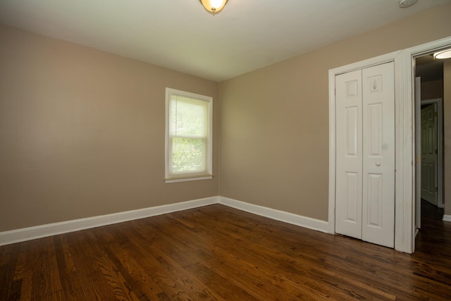2712 Voorheis Rd, Waterford, MI 48328 - unfurnished bedroom with dark wood-style flooring and a closet