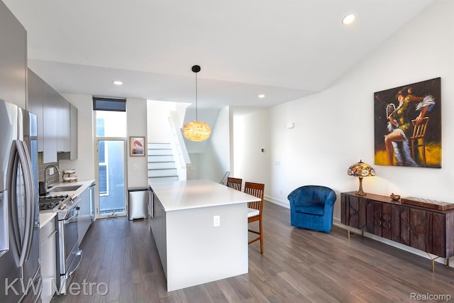 2821 Brush St, Detroit, MI 48201 - kitchen featuring stainless steel appliances, a breakfast bar, modern cabinets, dark wood-type flooring, and recessed lighting