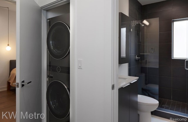 2821 Brush St, Detroit, MI 48201 - washroom with stacked washing machine and dryer and wood finished floors