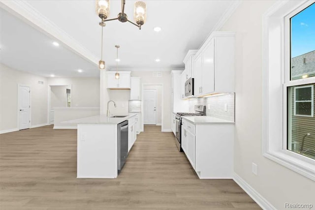 500 Jubilee Dr, Whitmore Lake, MI 48189 - kitchen featuring appliances with stainless steel finishes, a chandelier, crown molding, tasteful backsplash, and light wood-style flooring