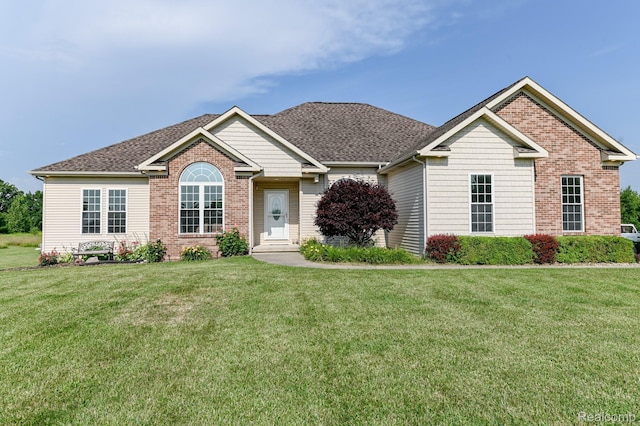 7396 Elms Rd, Swartz Creek, MI 48473 - view of front of property featuring a front yard, a shingled roof, and brick siding