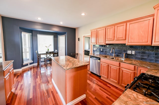 7396 Elms Rd, Swartz Creek, MI 48473 - kitchen featuring dishwasher, wood finished floors, black gas stove, decorative backsplash, and a center island