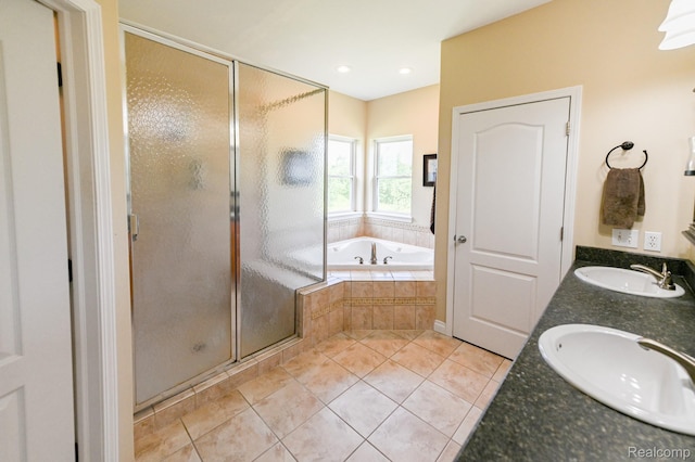 7396 Elms Rd, Swartz Creek, MI 48473 - full bath featuring a garden tub, a stall shower, tile patterned floors, and double vanity