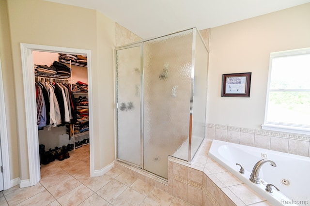 7396 Elms Rd, Swartz Creek, MI 48473 - full bath with a shower stall, a tub with jets, tile patterned flooring, and a walk in closet