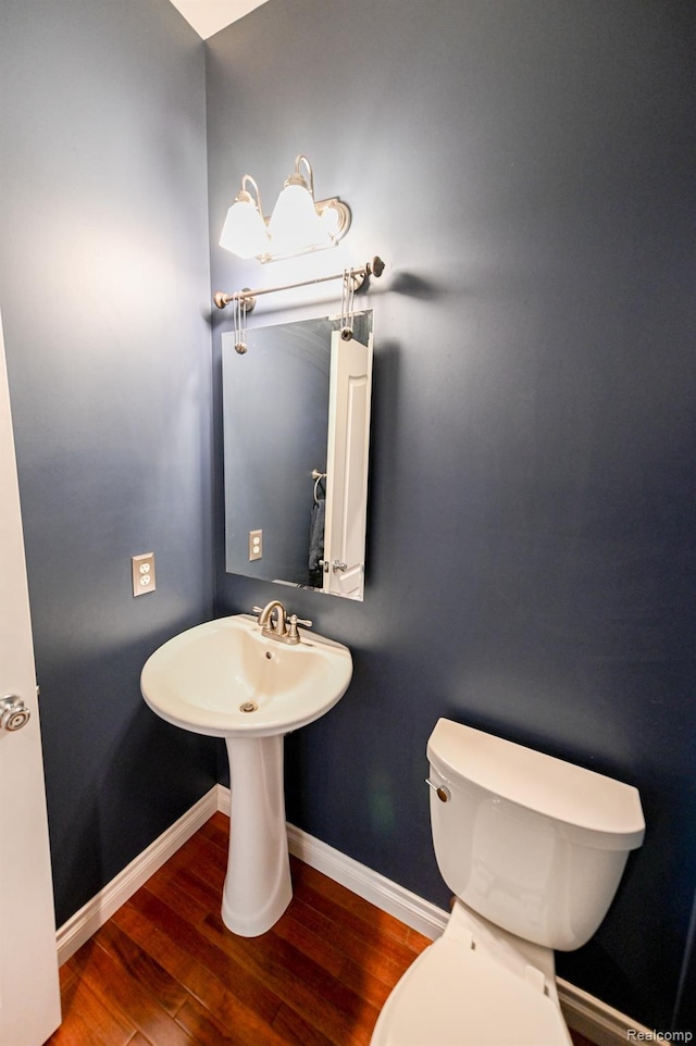 7396 Elms Rd, Swartz Creek, MI 48473 - half bathroom featuring wood finished floors and baseboards