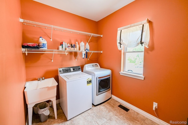 7396 Elms Rd, Swartz Creek, MI 48473 - laundry area with separate washer and dryer and baseboards