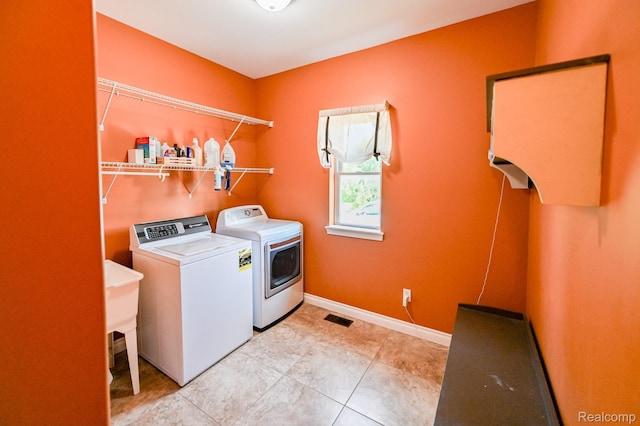 7396 Elms Rd, Swartz Creek, MI 48473 - laundry area with separate washer and dryer and light tile patterned flooring
