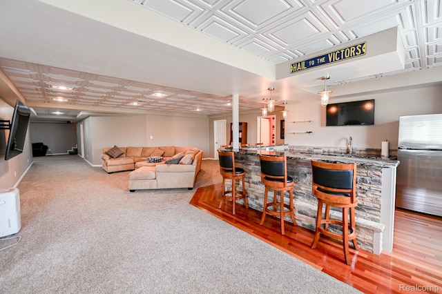 7396 Elms Rd, Swartz Creek, MI 48473 - living area featuring an ornate ceiling, bar with sink, recessed lighting, and light carpet