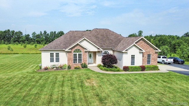 7396 Elms Rd, Swartz Creek, MI 48473 - ranch-style house with brick siding and a front yard