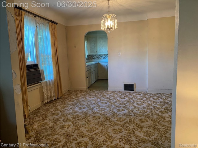972 Tacken St, Flint, MI 48532 - spare room with arched walkways, carpet flooring, a chandelier, and cooling unit