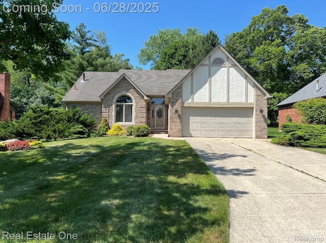 2184 Reagan Dr, Rochester Hills, MI 48309 - english style home featuring an attached garage, brick siding, a front yard, and concrete driveway
