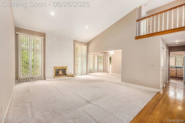 2184 Reagan Dr, Rochester Hills, MI 48309 - unfurnished living room with high vaulted ceiling, a brick fireplace, wood finished floors, and recessed lighting