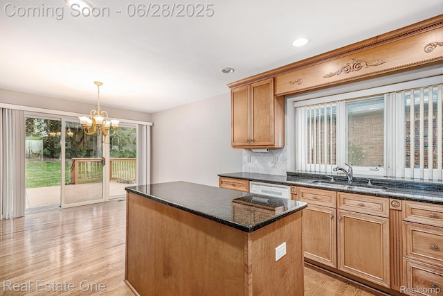 2184 Reagan Dr, Rochester Hills, MI 48309 - kitchen featuring a chandelier, a kitchen island, light wood-style flooring, dark stone counters, and decorative light fixtures