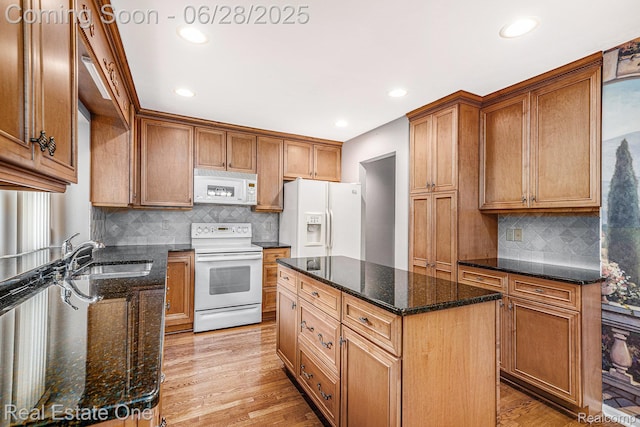 2184 Reagan Dr, Rochester Hills, MI 48309 - kitchen featuring white appliances, decorative backsplash, dark stone countertops, and recessed lighting