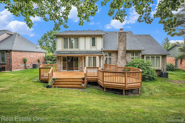 2184 Reagan Dr, Rochester Hills, MI 48309 - rear view of house with stucco siding, a yard, a chimney, a deck, and a shingled roof