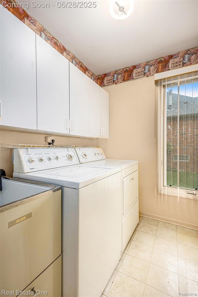 2184 Reagan Dr, Rochester Hills, MI 48309 - laundry room with washer and dryer, cabinet space, and light tile patterned floors