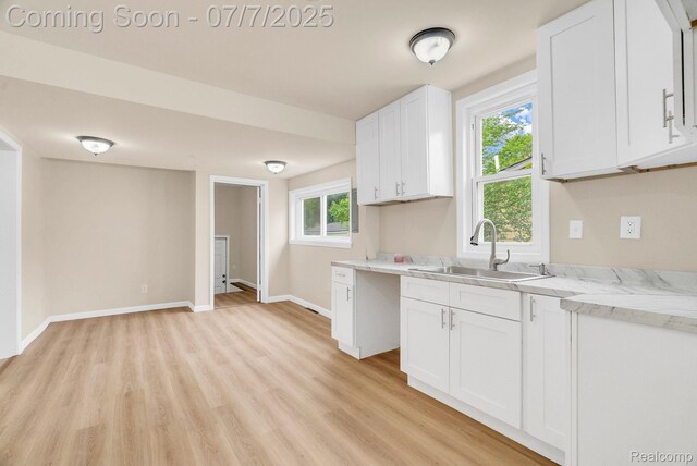 8716 Jewett Ave, Warren, MI 48089 - kitchen featuring light wood-style floors, white cabinets, plenty of natural light, and light stone countertops