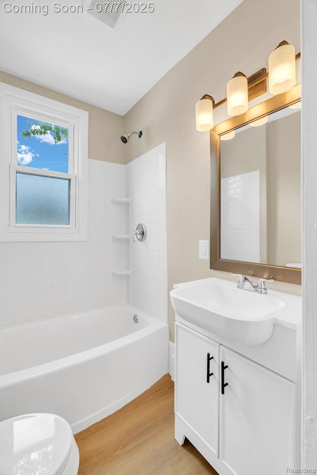 8716 Jewett Ave, Warren, MI 48089 - bathroom with wood finished floors, vanity, and bathtub / shower combination