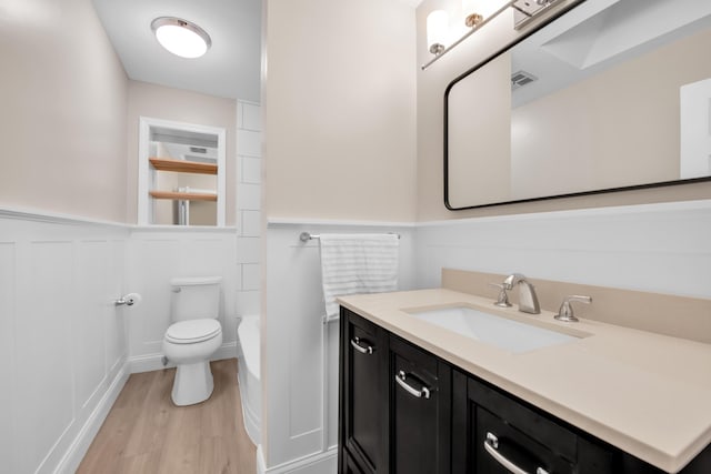 27152 Broadmoor Dr, Warren, MI 48088 - bathroom with a wainscoted wall, vanity, wood finished floors, a bathtub, and a decorative wall