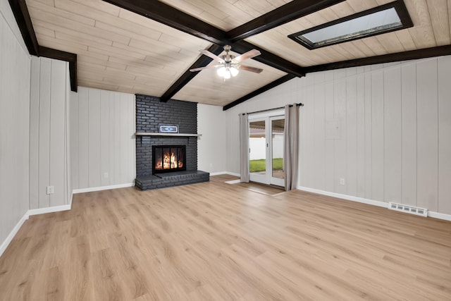 27152 Broadmoor Dr, Warren, MI 48088 - unfurnished living room featuring wood finished floors, a brick fireplace, ceiling fan, wooden ceiling, and a skylight